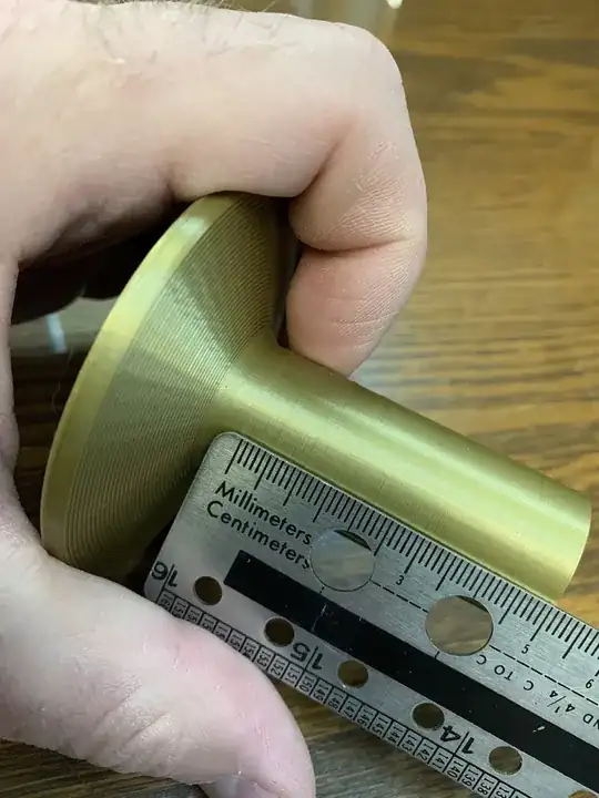 Photo of ruler measuring the evenly spaced horizontal bulges on the base of Christmas tree Photo of ruler measuring the evenly spaced horizontal bulges on the base of Christmas tree