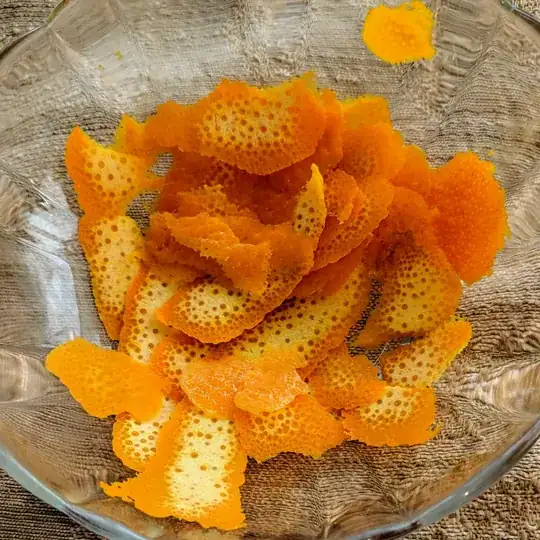 slices of orange peel in a glass bowl