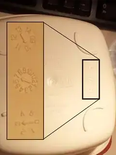 Clock-like symbols under plastic container