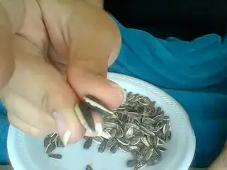 Place two seeds between your thumb and middle finger