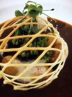 Slow-braised Black Angus ribs with sweetbread & morels in a choux pastry cage.