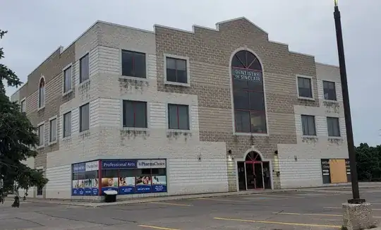 a building with dark patches on its brick exterior under every window