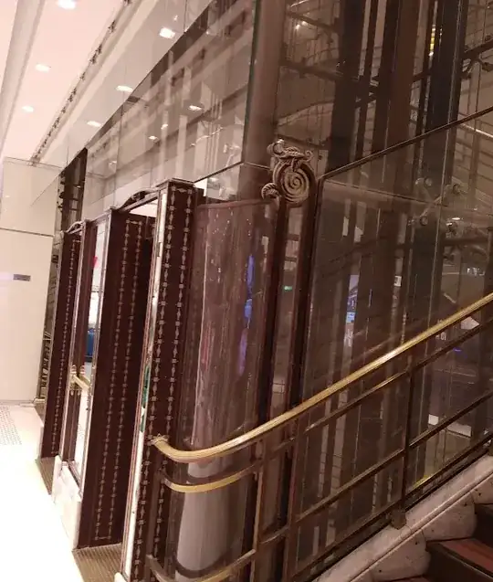 Glass panels attached to the edge of a ceiling in a shop