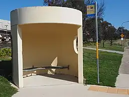 Bus stop shelter with signpost
