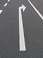 An arrow painted onto the pavement at the start or end of the turn lane