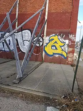 Support structures holding up a terraced house which are obstructing the sidewalk