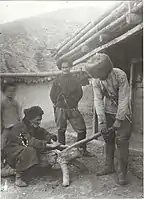 Men at work on a wooden tanning drum, Dzheyrakh village 1921