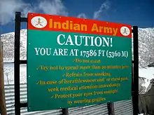 Sign displays "Caution! You are at 17586 ft (5360 m)"