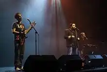 The Axis of Awesome (left to right: Lee Naimo, Jordan Raskopoulos, Benny Davis) performing c. 2011