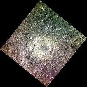 Approximate color image of Bartók at a high sun angle showing that the central peak is much darker than the floor and ejecta of the crater, with some areas that are much brighter