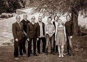 Big Big Train in 2014.Left to right: Andy Poole, Danny Manners, David Longdon, Rikard Sjöblom, Nick D'Virgilio, Dave Gregory, Rachel Hall and Gregory Spawton