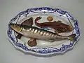 Palissy majolica c.1880. Platter is opaque white tin-glazed with cobalt oxide brush-painted decoration, the applied fish are of coloured glazes majolica.
