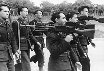Black-and-white photo of men in uniform with guns