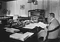 The Governor-General Johan Paul van Limburg Stirum behind his desk in his summer residence at Istana Cipanas, 1921