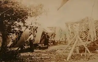 Fishermen working with nets on Detroit Island; from a postcard postmarked in 1909