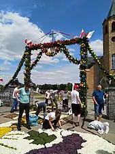 Gate and a fragment of a carpet at the entrance to the church, June 2021