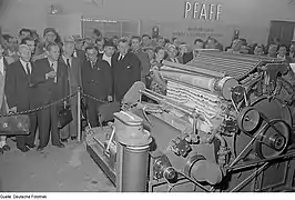 Visitors at the demonstration of a Pfaff textile machine at the 1953 Technical Fair