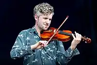 Tom Hobden pictured in 2022 playing the violin.