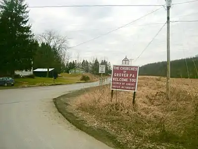 Sign for the churches of Grover, Pennsylvania as seen at a turn from State Route&nbsp;154 in February&nbsp;2012