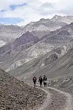 Hikers approach Mud on left bank of Pin