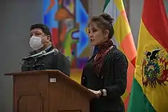 Isabel Fernández stands at a podium during a press conference.