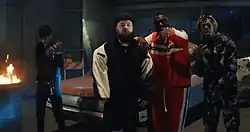The music video for "Down Like That" places Lil Baby, S-X, Rick Ross and KSI (from left to right) in a dystopian and apocalyptic warehouse, amongst motorcycles, burned out cars, trash can fires and rubble concrete.