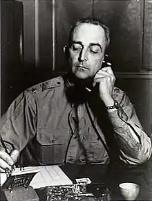 Black and white photo of Lieutenant Colonel Lester J. Whitlock sitting at a desk.