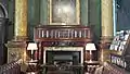 Fireplace in the current Smoking Room, National Liberal Club, note wooden mantle enclosing marble fire-surround, with dark tiles within the fireplace