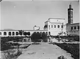 View of the menagerie courtyard in the southwestern corner of the palace, looking north, with the minaret of the Lalla Mina Mosque on the right (photo from 1913)