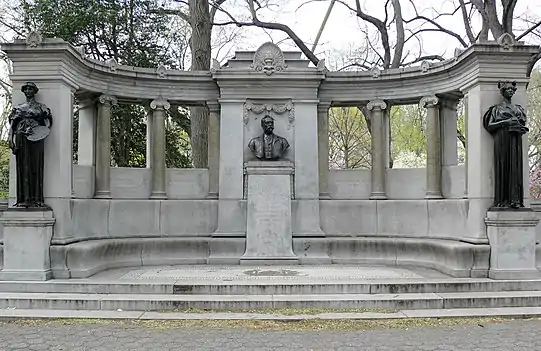 Three bronze statues on the left, center, and right of a larger curved stone structure
