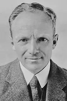 Sepia photograph of man in gray or beige woolen suit