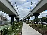 Elevated rail and landscaping leading to Preston station built by the Level Crossing Removal Project, July 2023.