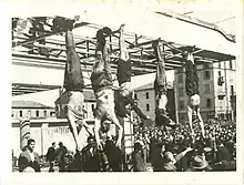 corpses hanging by feet including Mussolini next to Petacci at Piazzale Loreto, Milan, 1945