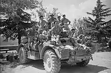 Large group of soldiers sitting on an armoured car