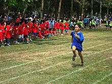 Image 6A child taking part in a local schools meeting in Cambodia (from Track and field)