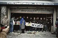 Colour photograph of a crowd of people, mostly young and white, demonstrating against eviction