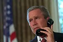 President Bush speaks on the phone to New York's Governor and Mayor respectively, George Pataki and Rudy Giuliani, two days after the September 11 attacks.(Draper, 2001)