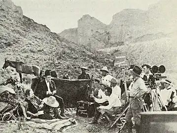 Publicity still of cast and crew on location