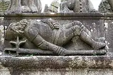 As the resurrected Jesus emerges from the tomb a soldier lies on the ground deep in sleep. Jesus' feet can be seen at the top of the photograph.