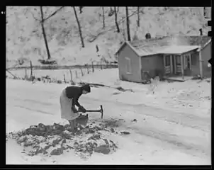 Woman gathering coal
