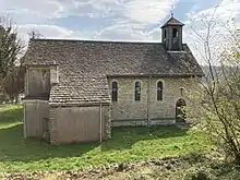 A cotswold stone simple chapel with a small bell turret.
