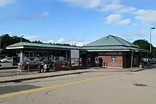 A brick railway station with a metal canopy