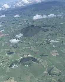 View to west of Te Kawa tuff ring (foreground), Kakepuku (middle distance) and Pirongia in distance