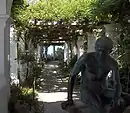 Pergola with Roman statue