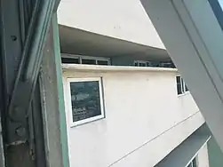 20 in (510 mm) separation between corridors showing apartment windows.