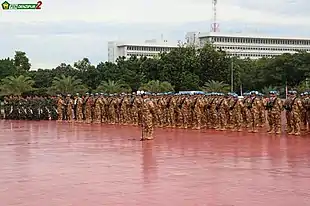 A formation military personnel in three ranks on the red parade ground at the headquarters of the Indonesian military