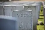 Tombstone of an unknown soldier at Tyne Cot Cemetery. The inscription uses Gill's Headstone Standard Alphabet.