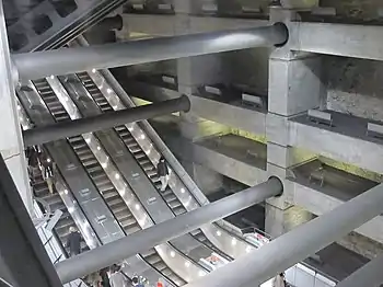 Image 35Escalators at Westminster Underground station descend between beams and columns of the station box to reach the deep-level Jubilee line platforms.