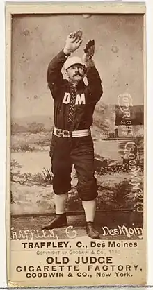 Standing man in baseball uniform catching a ball