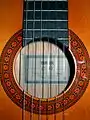 close-up view of rosette on modern classical guitar.